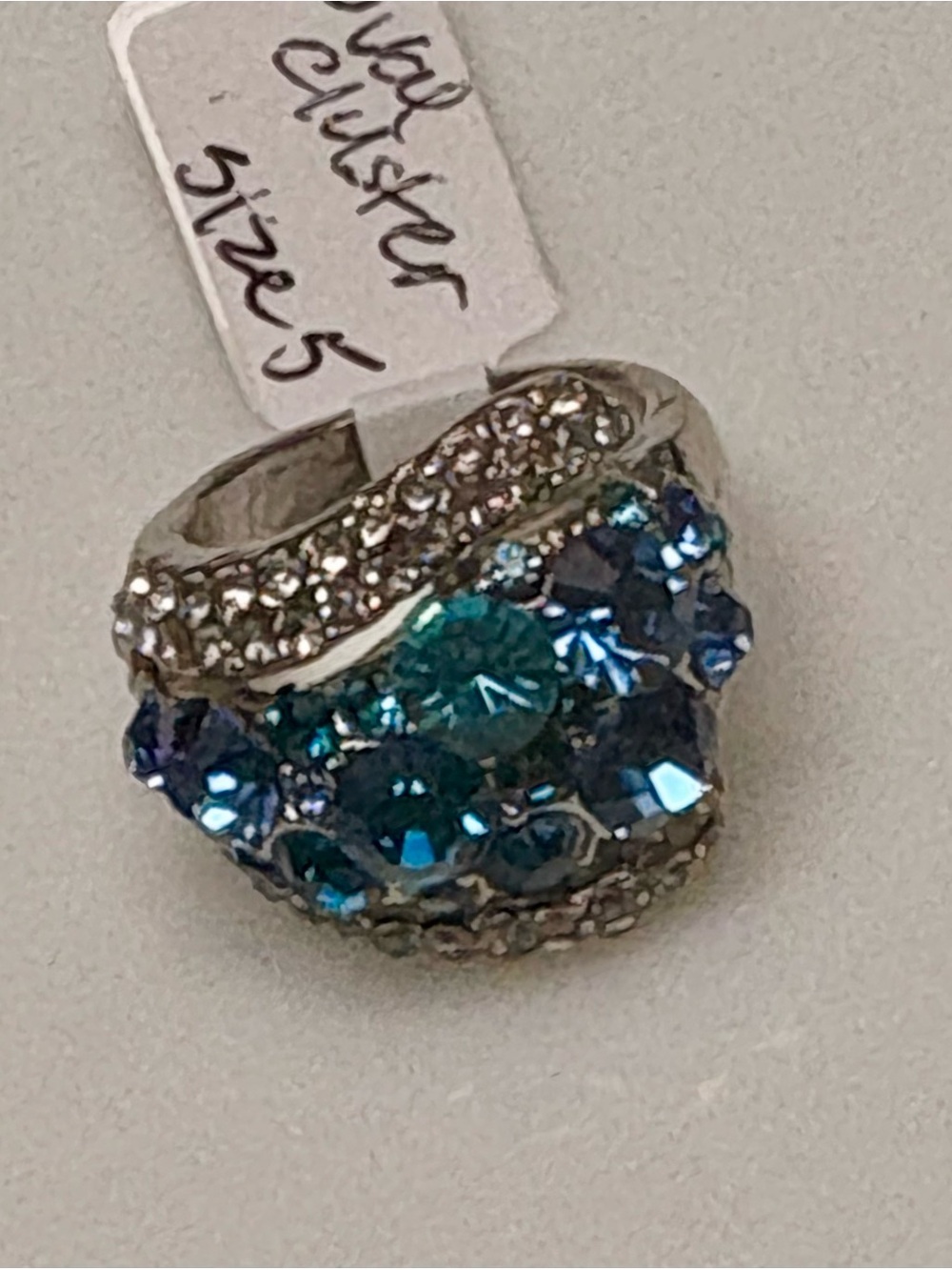 Silver tone statement ring w/sparkling blue & teal crystal cluster.Size 5